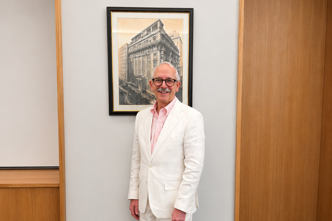 This image shows F. Michael Angelo standing in front of an artwork at his retirement ceremony in May 2026.