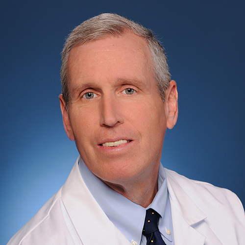This image shows Dr. Gregory Kane in a white lab coat.
