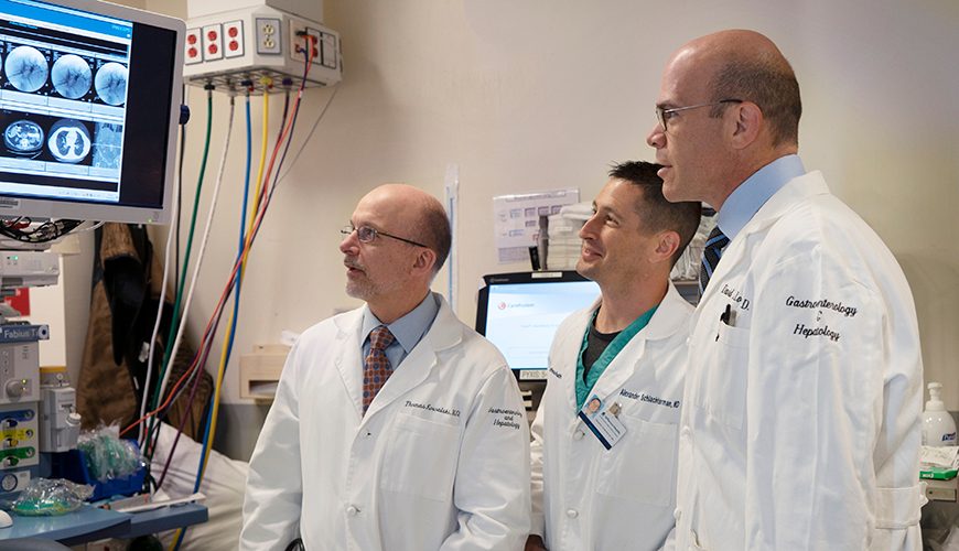 Drs. Loren and Kowalski looking at a screen showing medical imaging