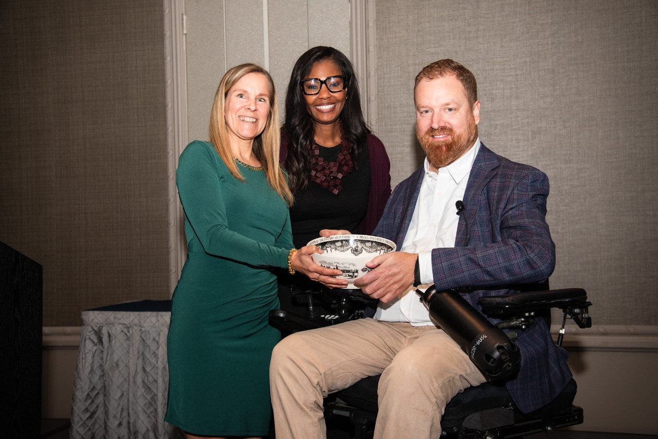 Eli Kulp (right) holding the 2025 Humanitarian Award from Jefferson Moss-Magee Rehabilitation.