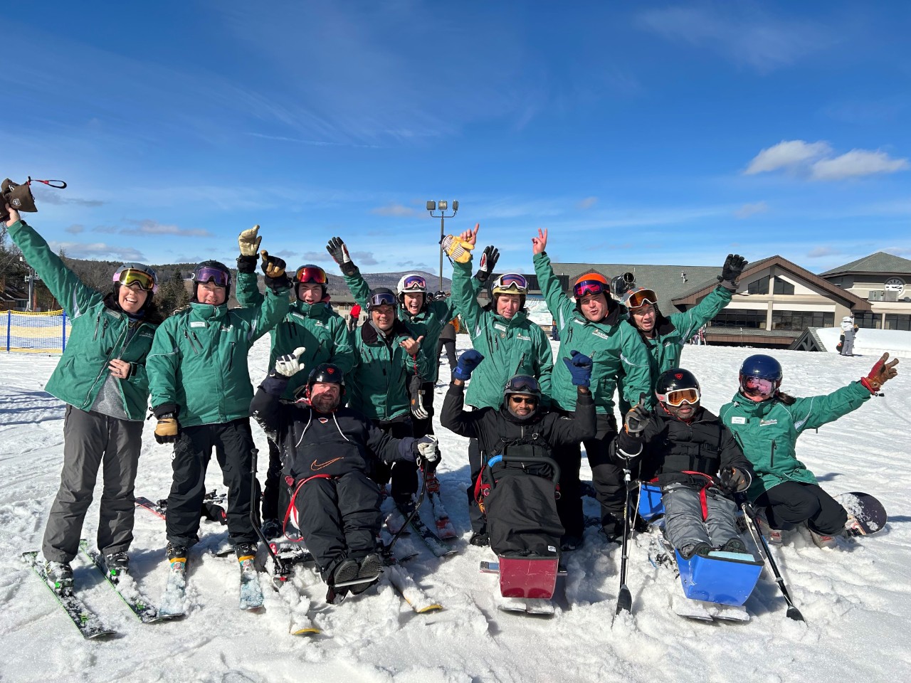 This image shows participants of the Jefferson Moss-Magee Rehabilitation Spinal Cord Injury Activity Group on a ski trip.