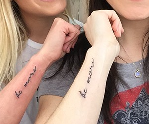 Erin and Breanna showing their matching tattoos
